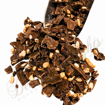 Chocolate peanut brittle pieces with nuts on a white background
