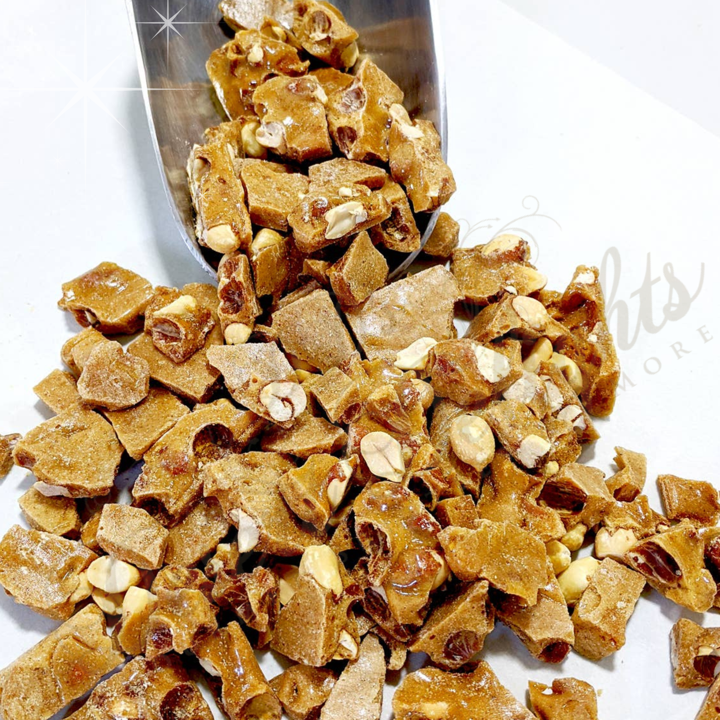 Candied jalapeno peanut brittle candy with a metal scoop on a white background