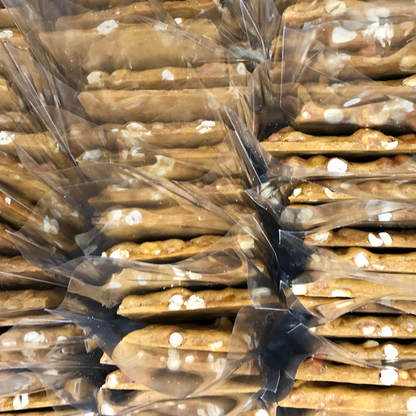 Stack of wrapped pretzel rods with clear plastic packaging.