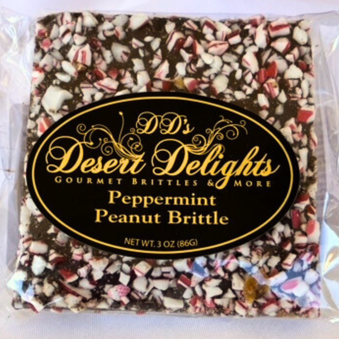 Packaged peppermint peanut brittle with 'DD's Desert Delights' label on a white background